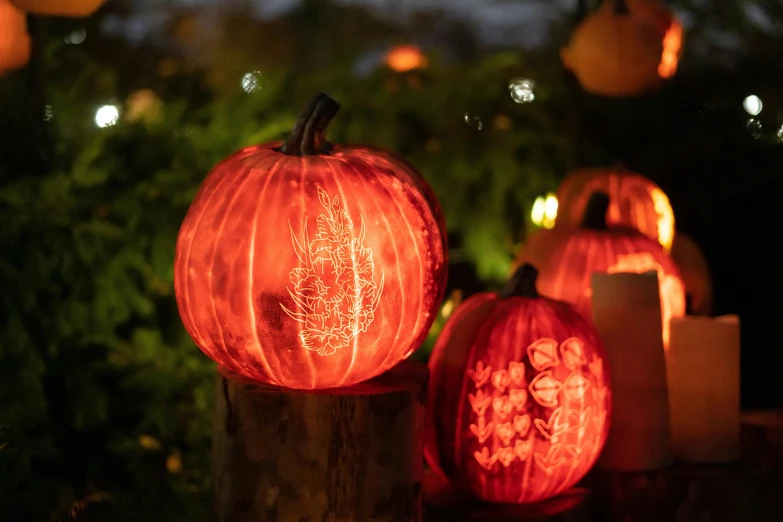a pumpkin decorated with designs with candles beside it
