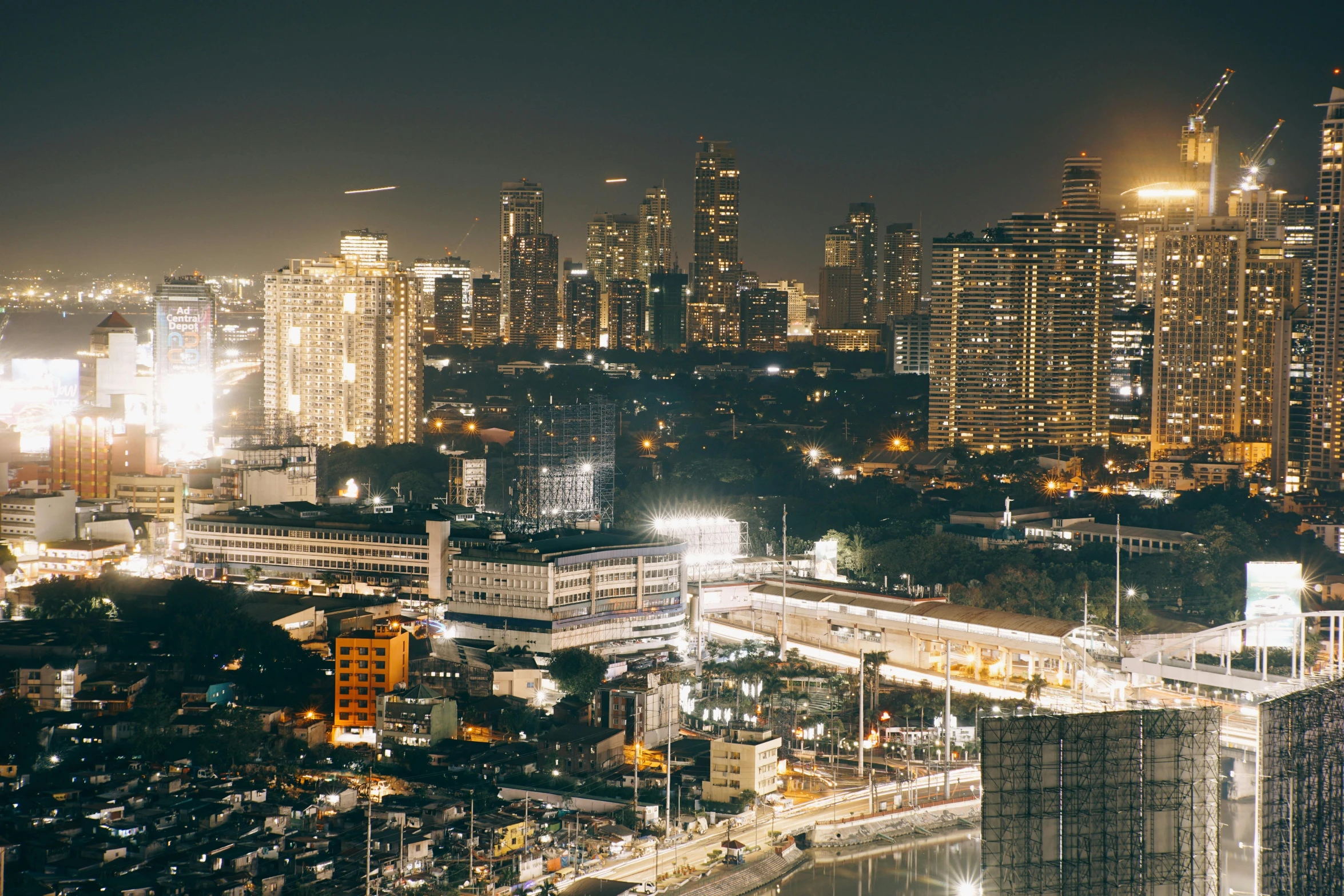 the city skyline is lit up in several bright lights