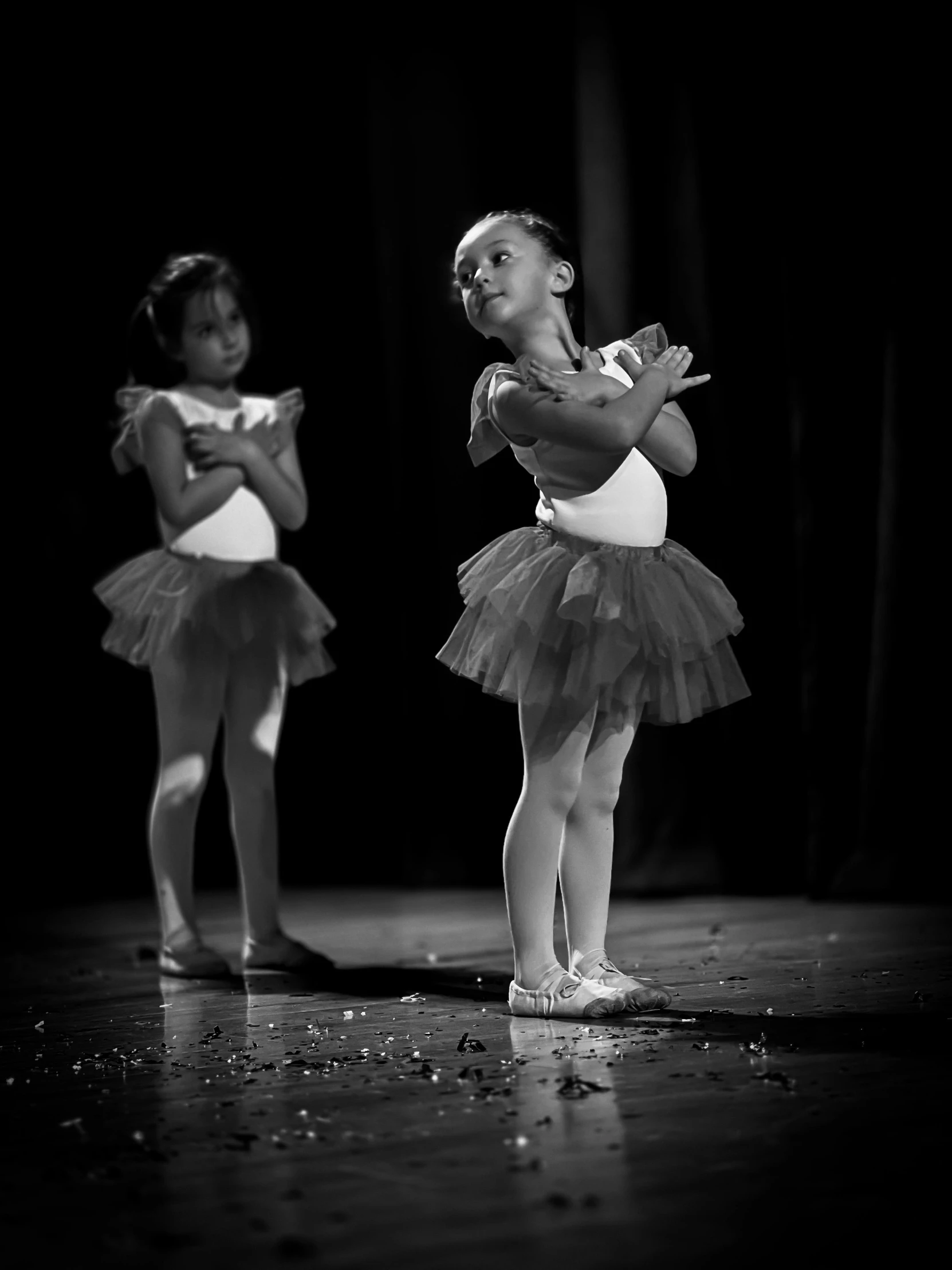 two little girls in ballet outfits on stage