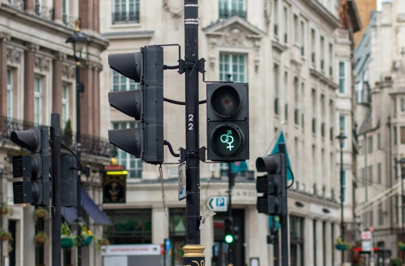 traffic lights and a street sign near a city street