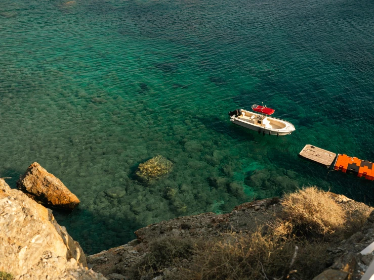 a boat is anchored to the shore near a dock