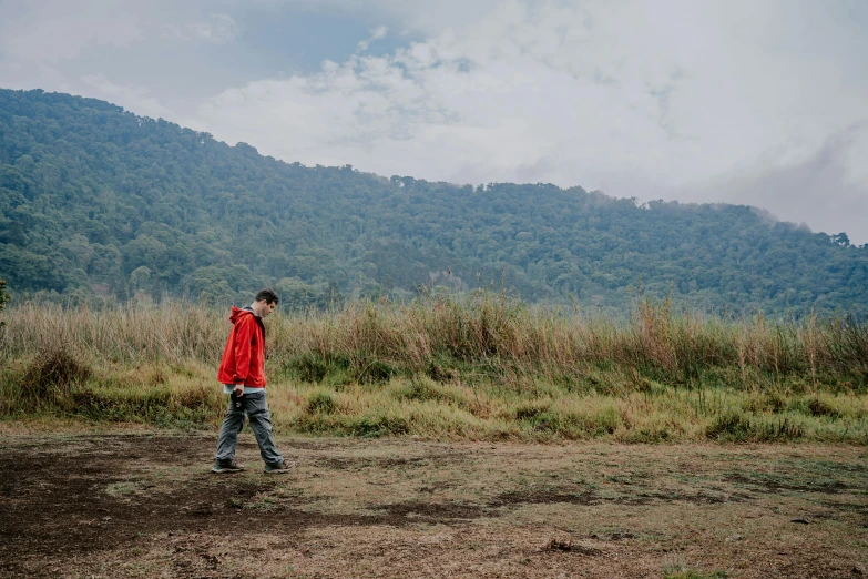 a person is standing in front of a large mountain