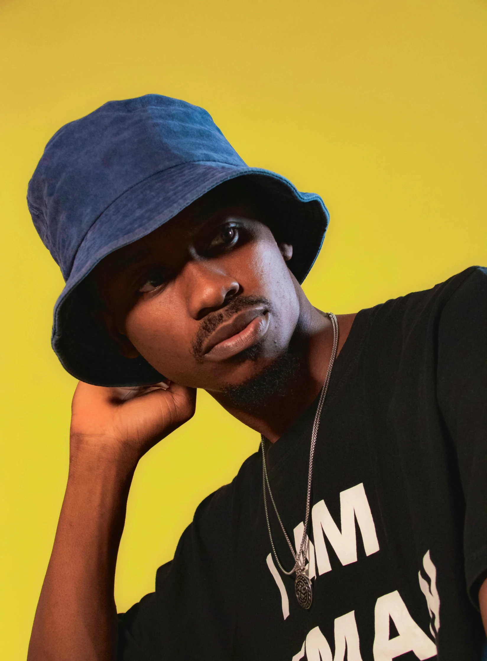 a man poses for the camera wearing a baseball hat