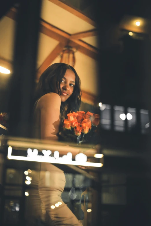 a woman standing with flowers in her hand