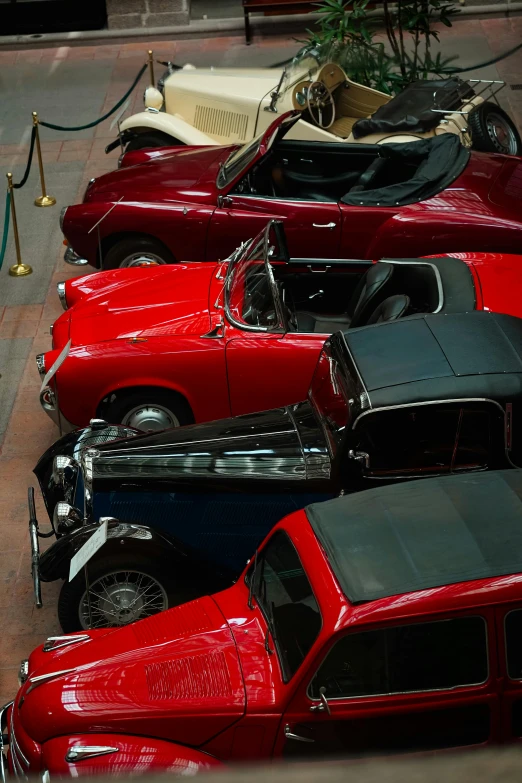 a row of older cars with old time automobiles on display