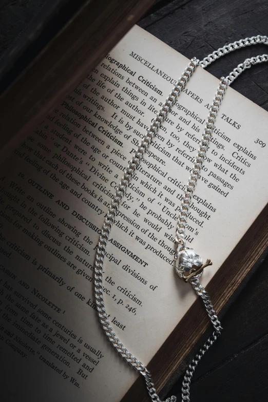 a book with some sort of silver chain