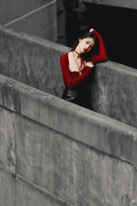 a black and white po of a woman leaning against a ledge