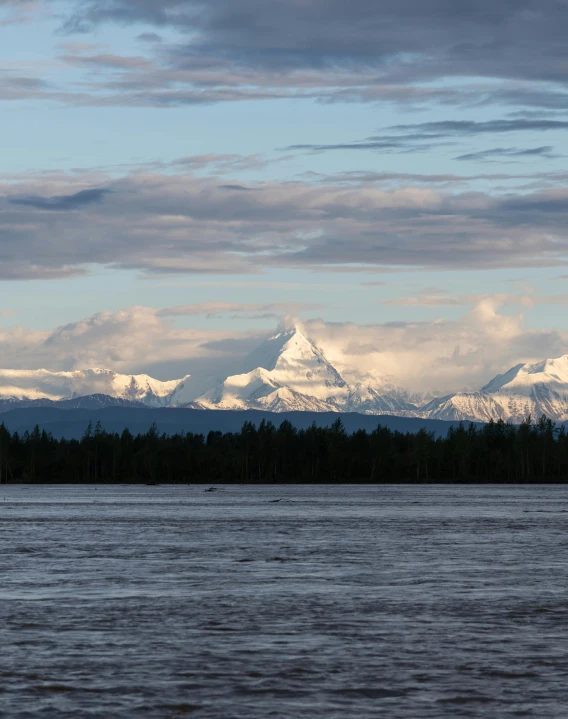 a lake with a very large mountain in the distance