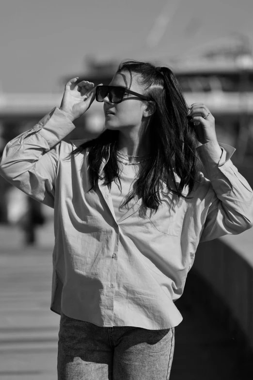 a woman is standing outside and listening to music