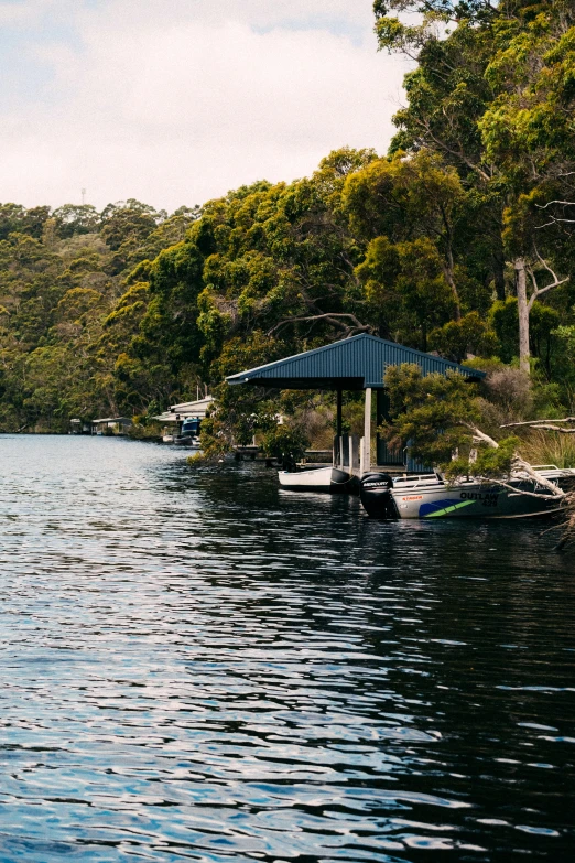 there is a boat in the water with a covered pier