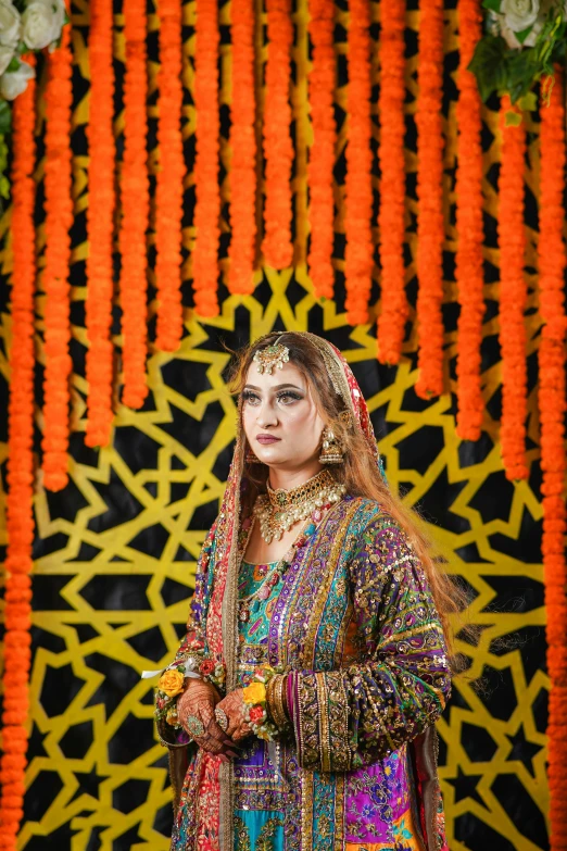 a woman in a colorful dress poses for a po