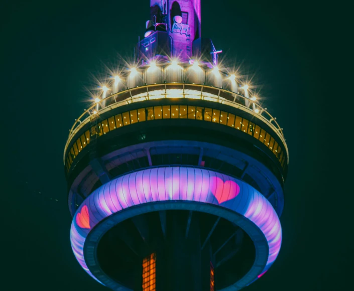 the top of a tower with a sky lit area behind it