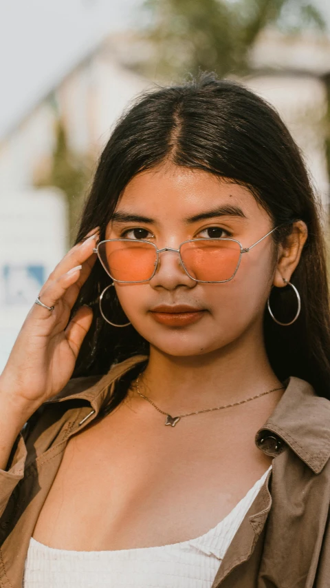 a young woman wearing red mirrored sunglasses