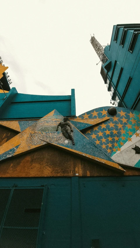 an upward view of a very tall building with a very decorative roof