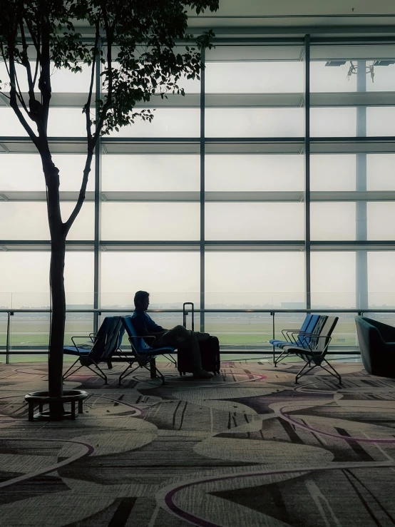 a person sitting in a chair with luggage