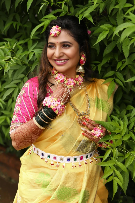 an indian girl poses for a pograph holding her jewelry