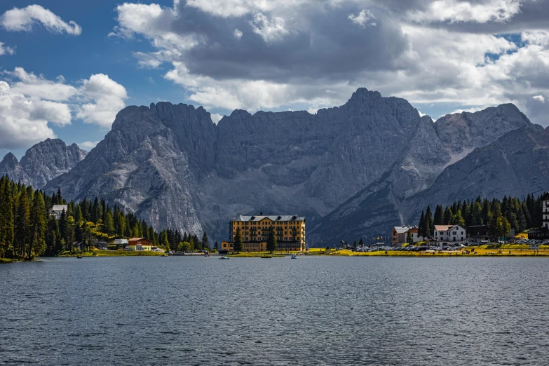 houses on a lake are near the mountains