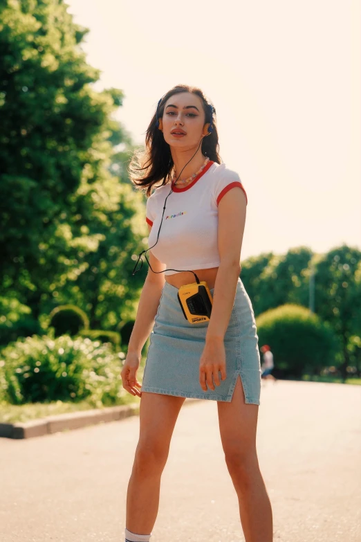 the woman has a skate board standing on a street