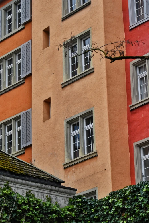 a building with three balconies on top and four windows