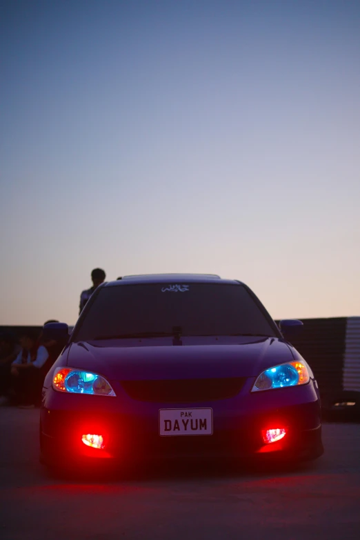 the car is parked outside at night time