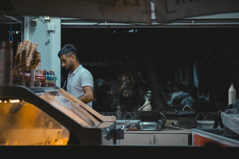 a man standing in front of a pizza oven next to some  dogs