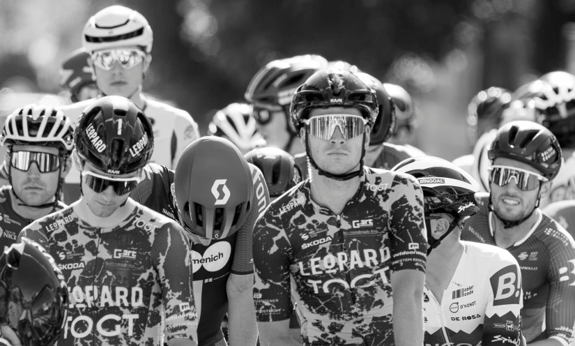 b w pograph of group of bicyclists looking towards camera