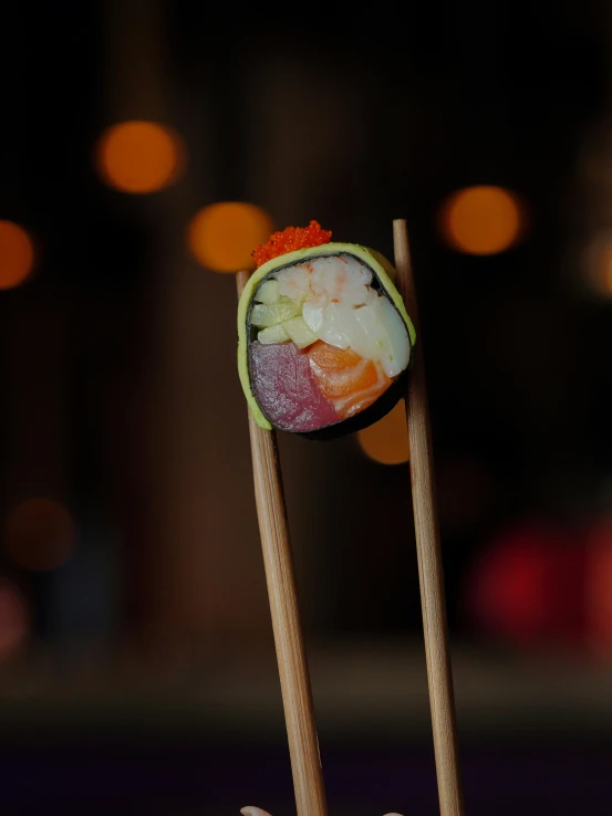 two chopsticks and some food on top of a table