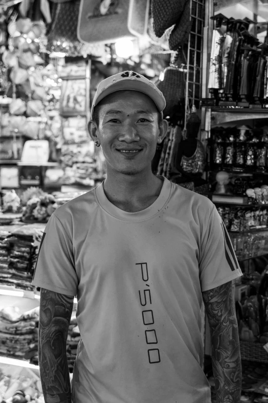 a man wearing glasses stands in front of a store