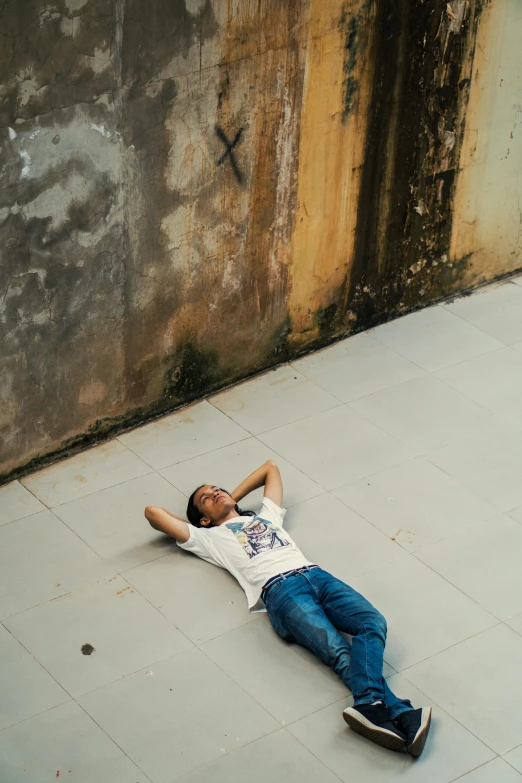 a young man laying down on the ground