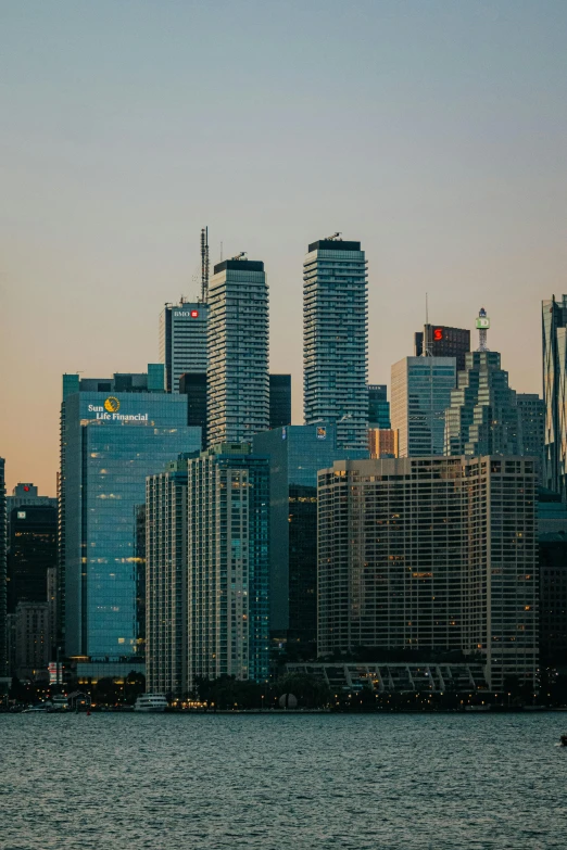 the skyscrs are shining in the sky at dusk