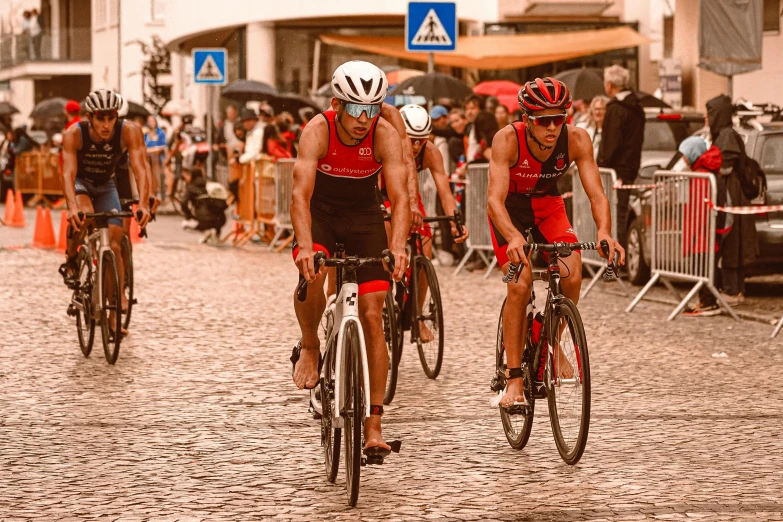 a group of men riding bicycles down a street