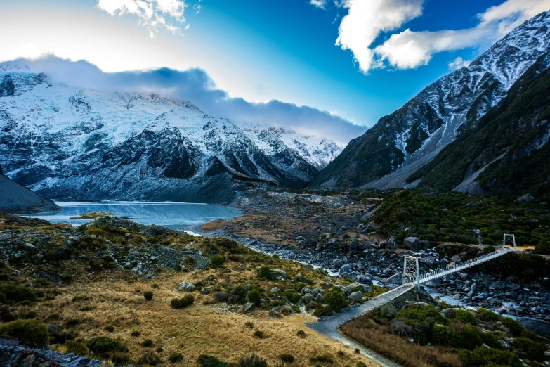 a view of the mountains and valley near a mountain lake