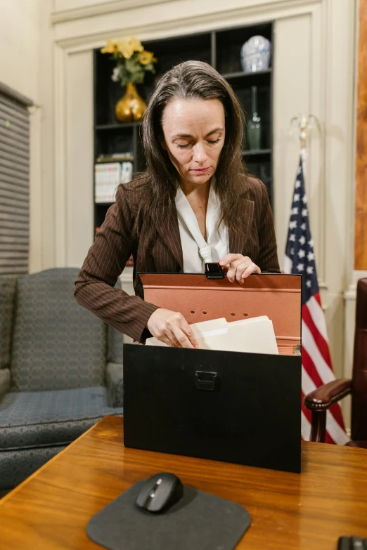 a woman sitting down with a laptop in front of her