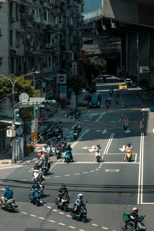 people riding motorcycles down the middle of the road