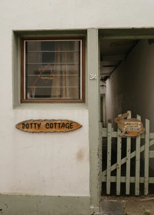 an entrance to a building that has potty cottage written on it