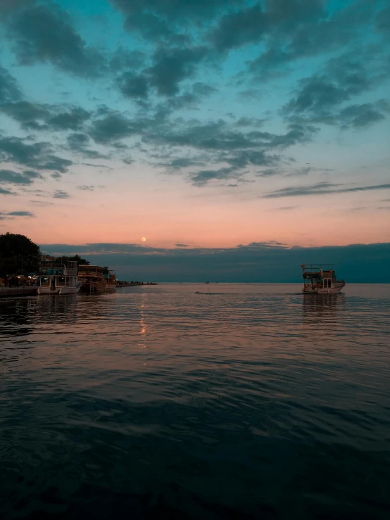 two boats on the water at sunset time