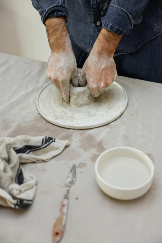 a person is shaping dough with their hands