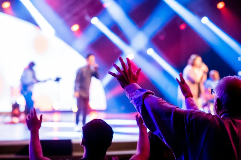 a crowd of people standing on top of a stage