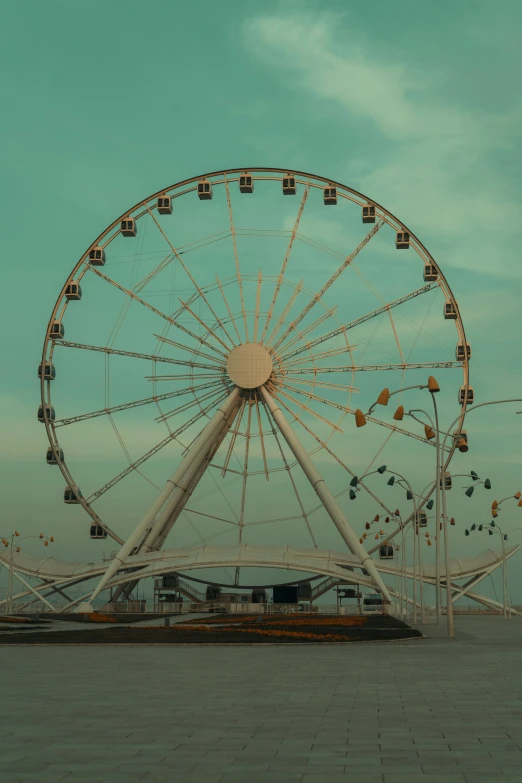 an abandoned ferris wheel in a empty lot