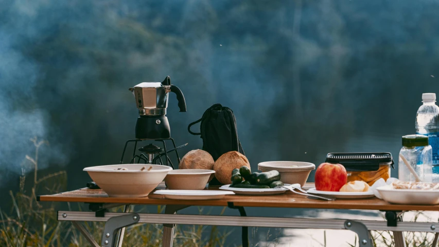 an outdoor camping table is set up to prepare lunch