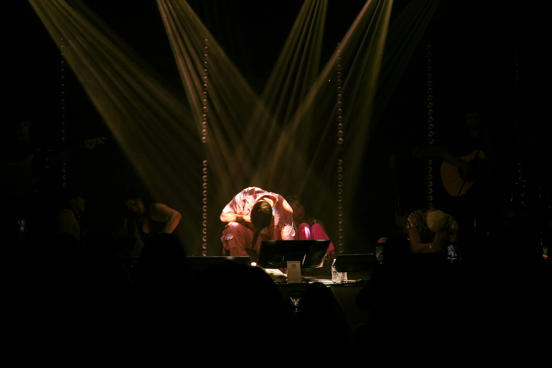 a group of people stand in front of large lights