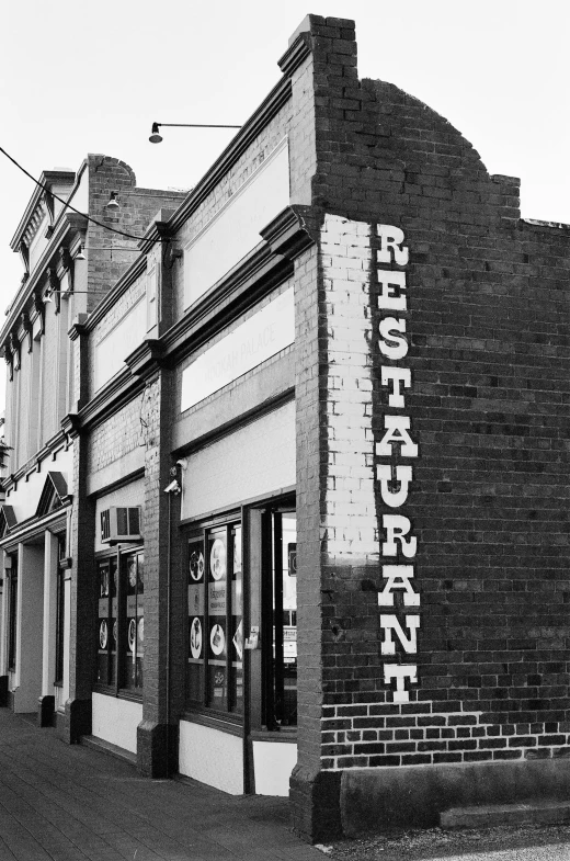 an old brick building with a store sign above it