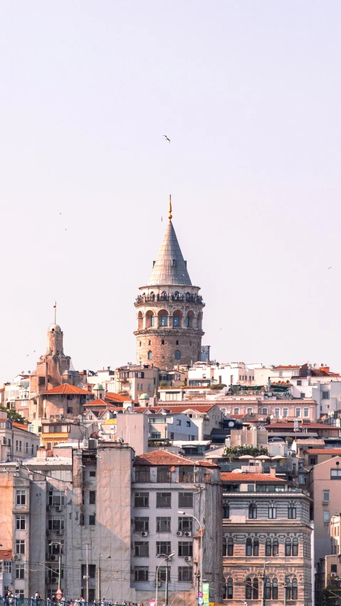 a large building is shown behind other buildings