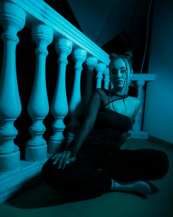 a young woman is sitting on the stairs alone