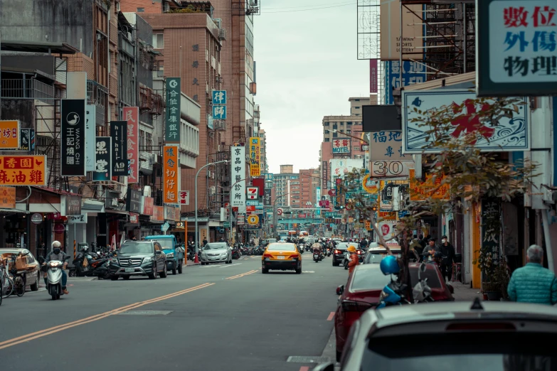 a city street lined with buildings with chinese signs