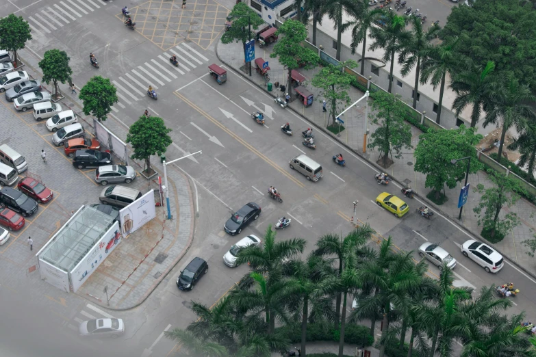 people are walking and cars in traffic on a city street