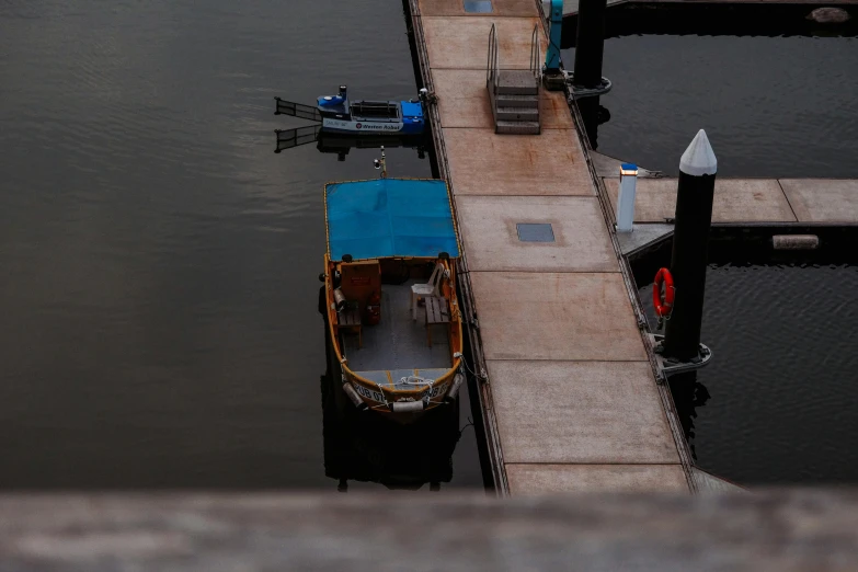 a dock sitting on the water with a small boat