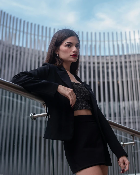 young female wearing black outfit with open shoulders and jacket