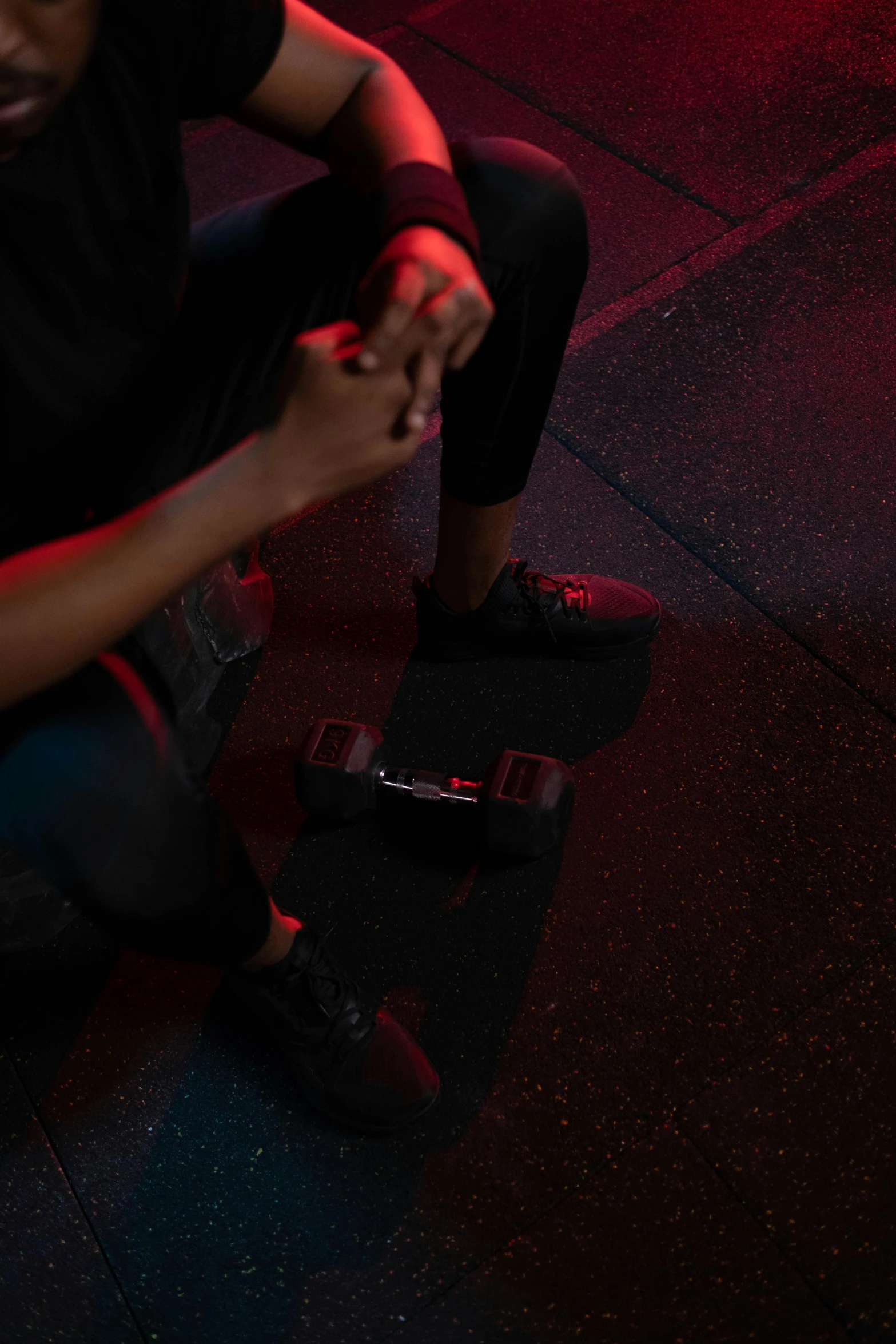 a man sits on top of a skateboard with his hands clasped up