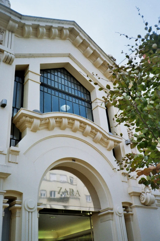 a large white building has a large arched entrance